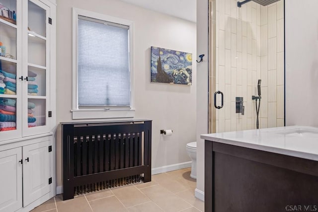 full bath with baseboards, toilet, tile patterned flooring, and a shower stall