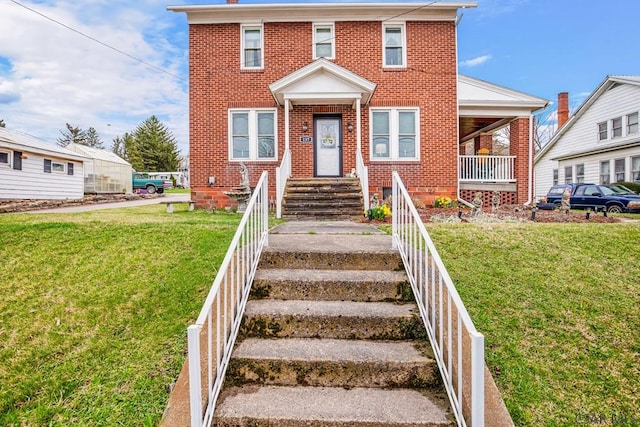 view of front of house with brick siding and a front yard