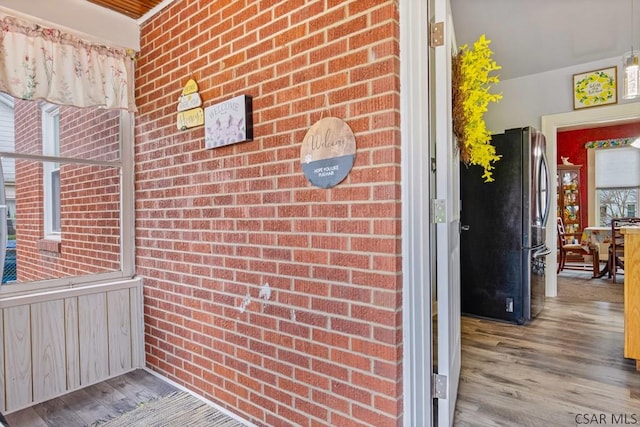property entrance featuring brick siding
