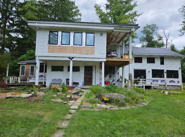 909 Snake Rd, Ebensburg, PA 15931 - view of front of property featuring covered porch, a front yard, a balcony, and metal roof