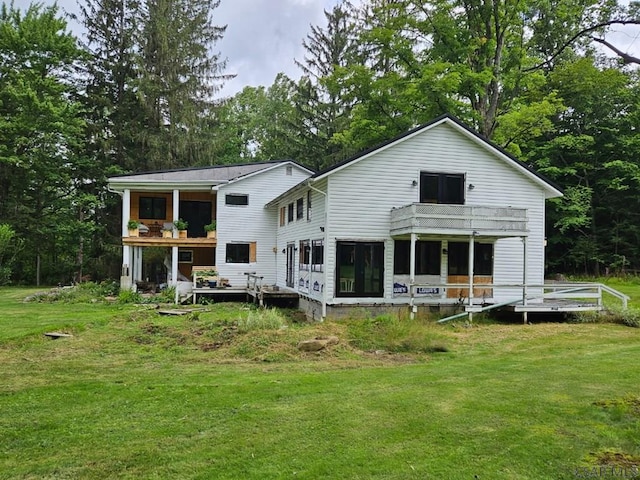 909 Snake Rd, Ebensburg, PA 15931 - rear view of house with a balcony, a lawn, a deck, and view of scattered trees