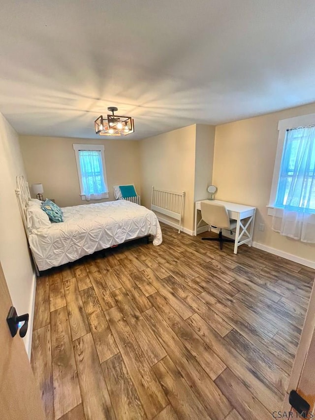 909 Snake Rd, Ebensburg, PA 15931 - bedroom with wood finished floors, baseboards, and a chandelier