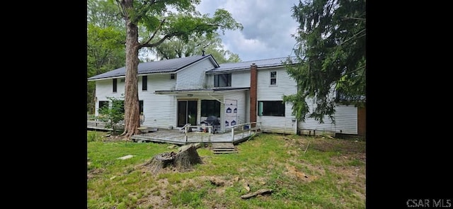 909 Snake Rd, Ebensburg, PA 15931 - rear view of house with a wooden deck, metal roof, and a yard
