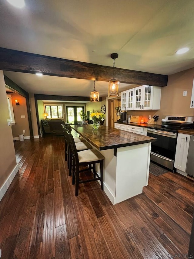 909 Snake Rd, Ebensburg, PA 15931 - kitchen featuring stainless steel electric range oven, wooden counters, dark wood-style flooring, white cabinetry, and glass insert cabinets