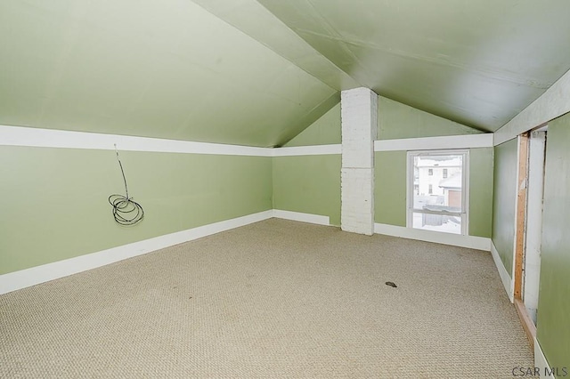 bonus room with lofted ceiling and carpet flooring