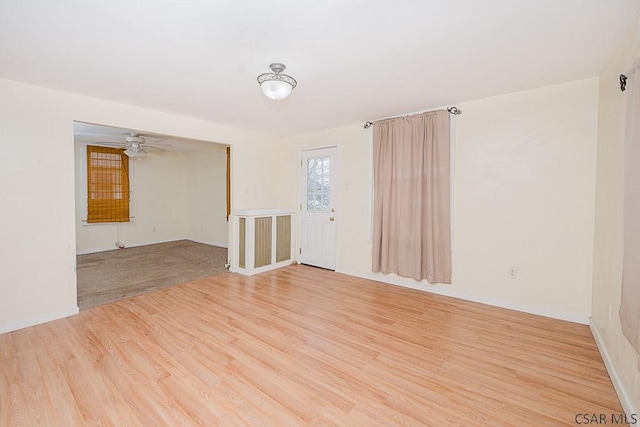 spare room featuring ceiling fan and light hardwood / wood-style flooring