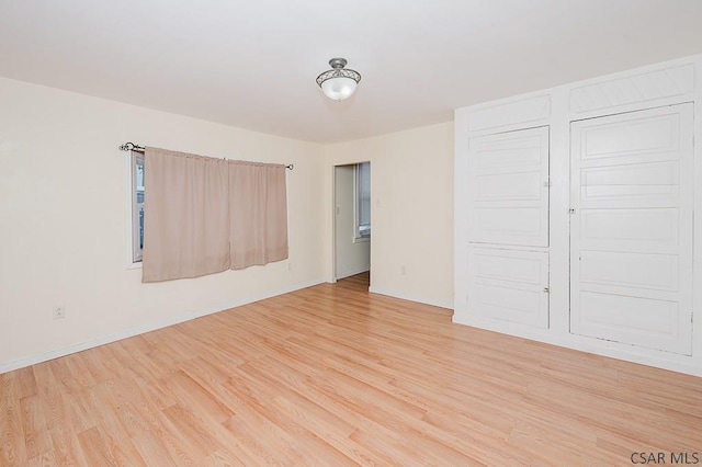 empty room featuring wood-type flooring