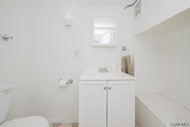 bathroom with vanity, tile patterned floors, and toilet