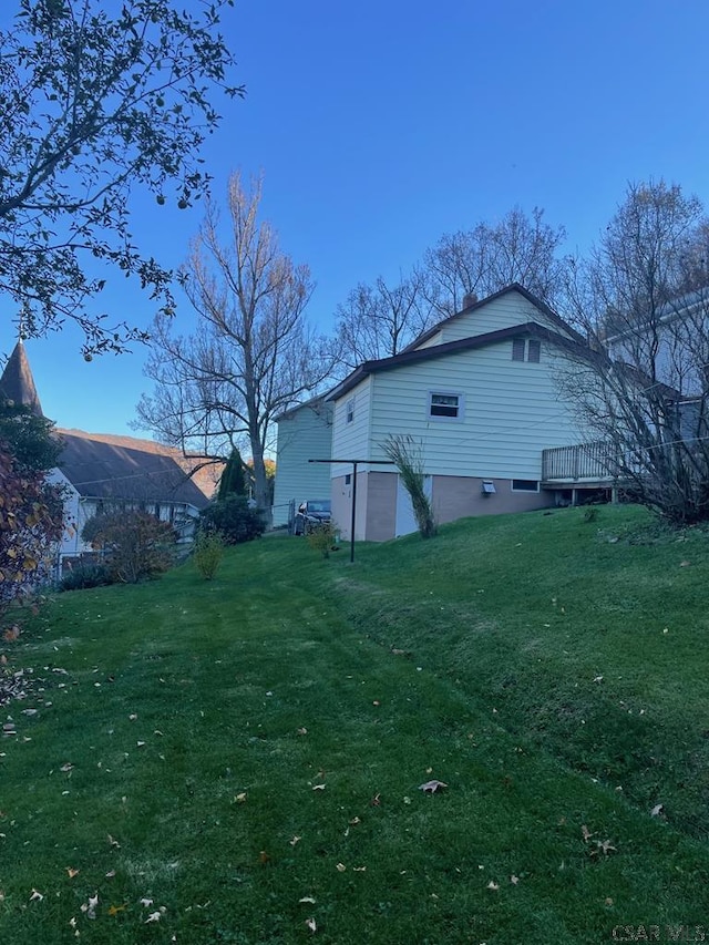 view of home's exterior with a yard and a deck