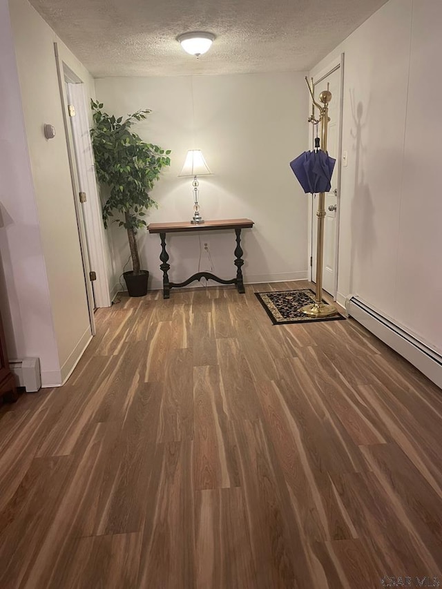 hallway featuring dark wood-type flooring and a textured ceiling