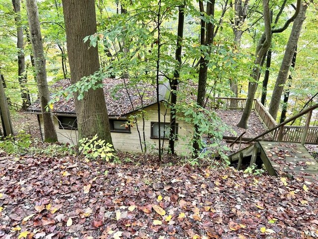 view of property exterior with a deck