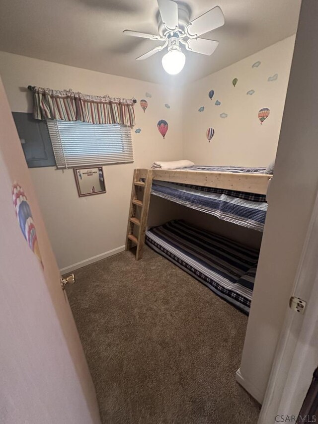 bedroom featuring ceiling fan and dark carpet