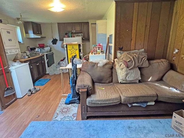 1840 Soap Hollow Rd, Tire Hill, PA 15959 - living room featuring estacked washer and dryer, a textured ceiling, and light wood-type flooring