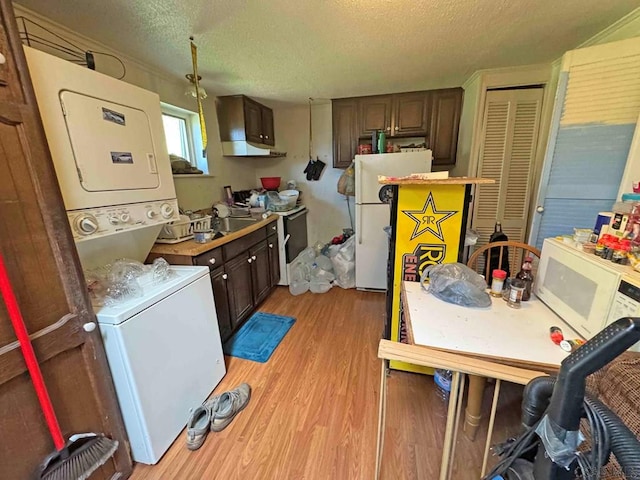 1840 Soap Hollow Rd, Tire Hill, PA 15959 - kitchen with white appliances, stacked washing machine and dryer, light wood-style floors, a textured ceiling, and dark brown cabinets