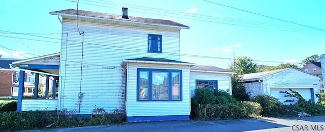 view of front facade with an outbuilding and a garage