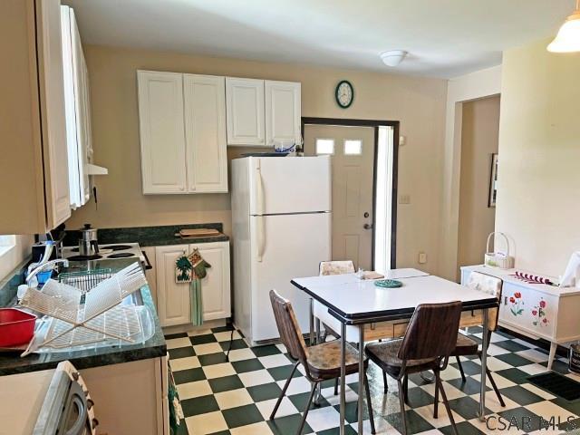 1310 Krayn Rd, Windber, PA 15963 - kitchen with freestanding refrigerator, light flooring, dark countertops, and white cabinets