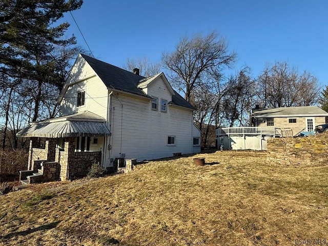 view of property exterior featuring a lawn