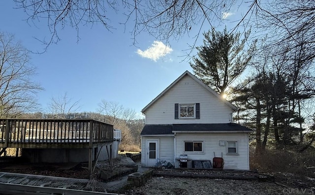 back of property with a wooden deck