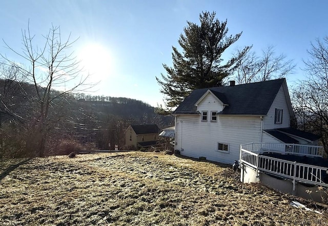 view of home's exterior with a wooden deck