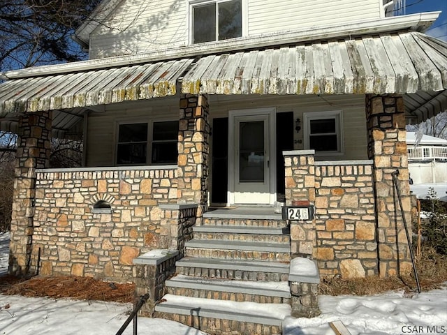 view of snow covered property entrance