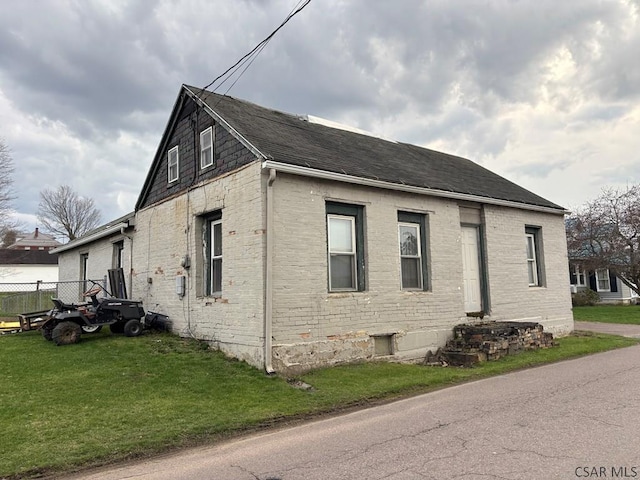 view of side of property with a yard and fence
