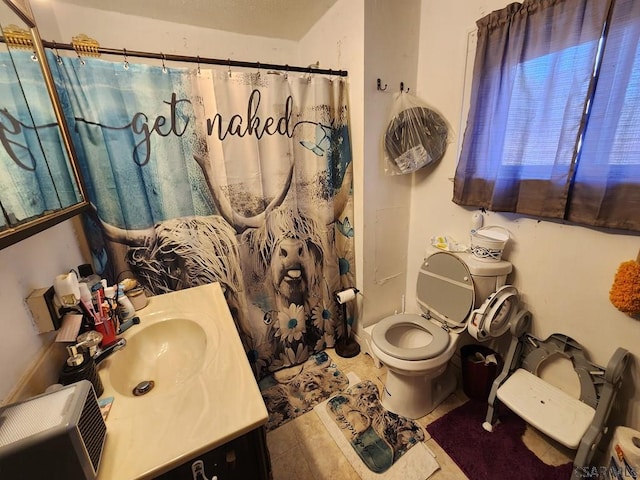 bathroom with walk in shower, vanity, toilet, and tile patterned flooring