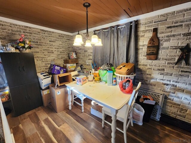 dining room featuring brick wall, dark wood-type flooring, and wood ceiling