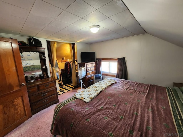 bedroom featuring vaulted ceiling and carpet floors