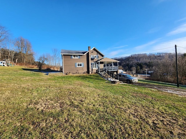 rear view of property with a yard