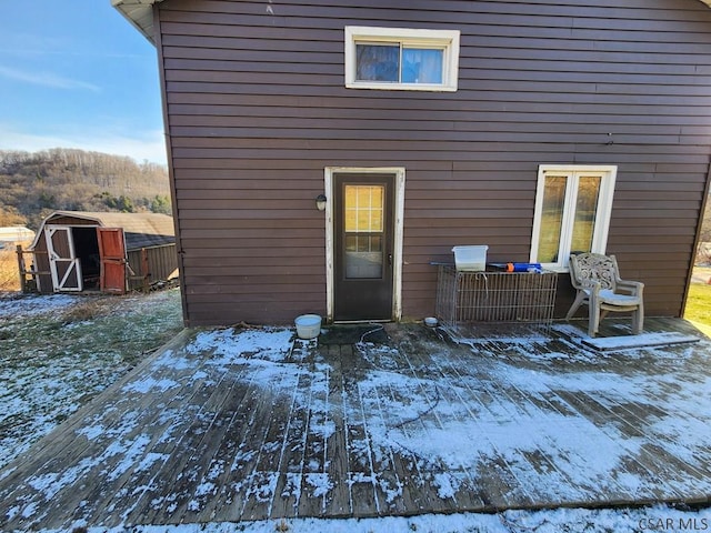 snow covered property featuring a deck