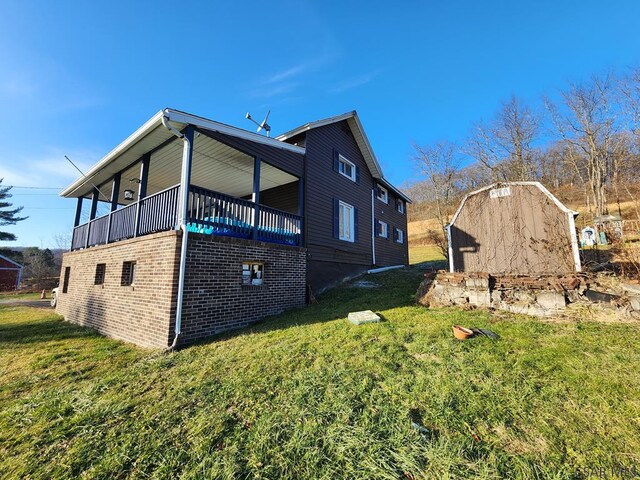 view of home's exterior featuring a yard and a balcony