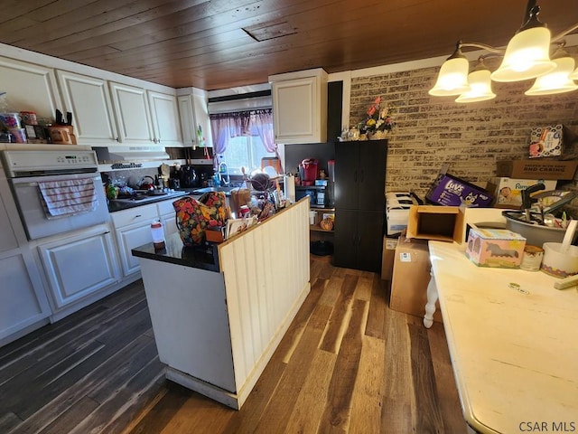 kitchen with wood ceiling, dark wood-type flooring, white oven, white cabinetry, and hanging light fixtures