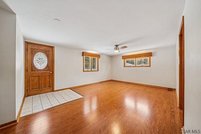 entrance foyer featuring ceiling fan, baseboards, and hardwood / wood-style flooring