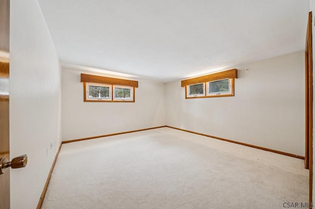 unfurnished room featuring carpet and baseboards