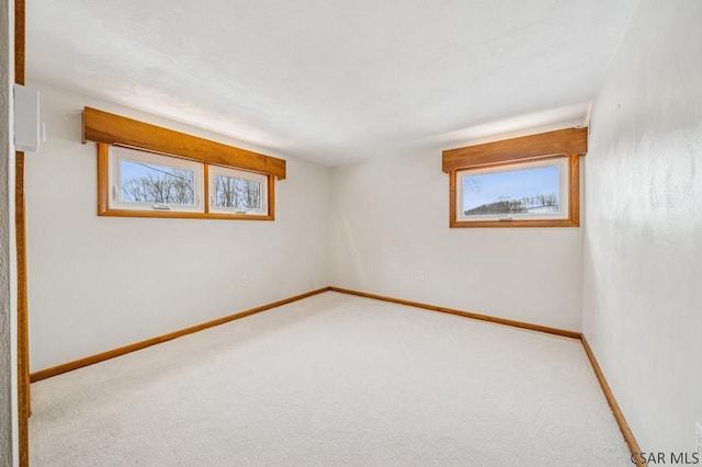 unfurnished room featuring carpet flooring and baseboards