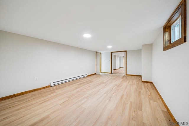 unfurnished room with light wood-style floors, baseboards, baseboard heating, and recessed lighting