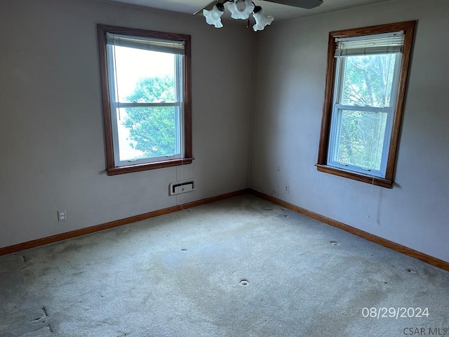 carpeted empty room with plenty of natural light