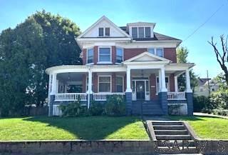 traditional style home with a porch and a front lawn