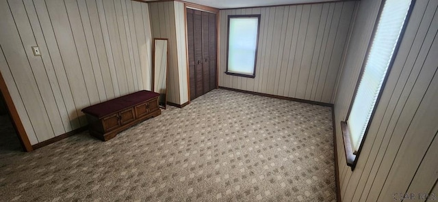 bedroom with light carpet and a closet