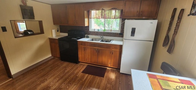 kitchen with white fridge, black electric range, sink, and dark hardwood / wood-style floors