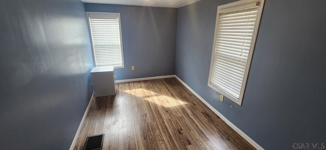 spare room featuring dark hardwood / wood-style floors