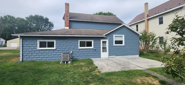 back of house with central AC unit, a yard, and a patio