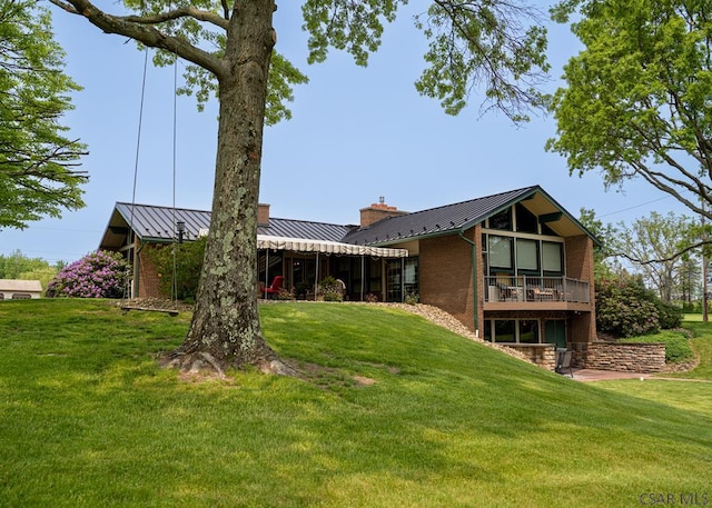 rear view of property featuring a yard