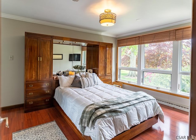 bedroom with a baseboard radiator, ornamental molding, and dark hardwood / wood-style floors