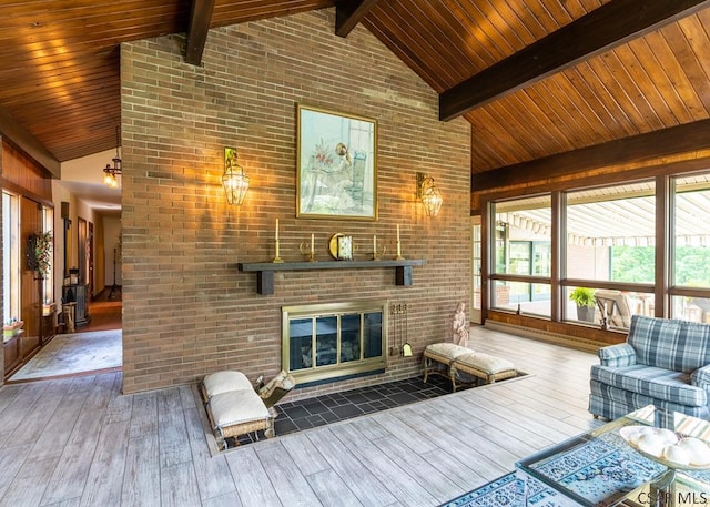 unfurnished living room featuring high vaulted ceiling, a brick fireplace, hardwood / wood-style floors, and beam ceiling