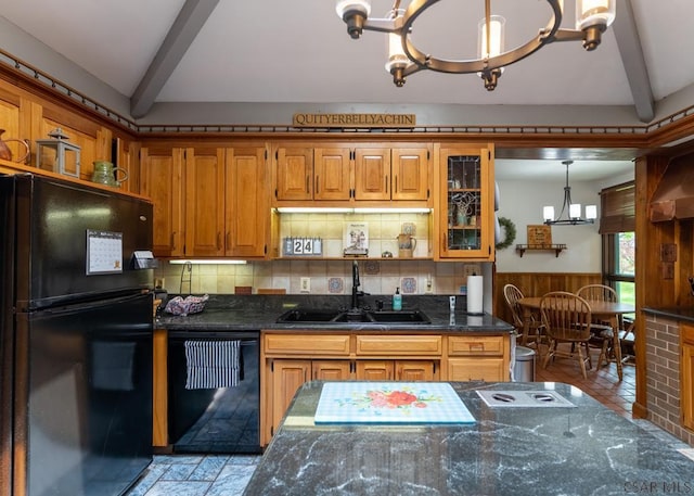 kitchen with sink, an inviting chandelier, hanging light fixtures, black appliances, and dark stone counters