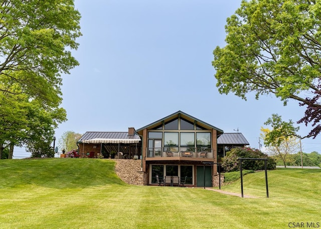 rear view of property with a yard