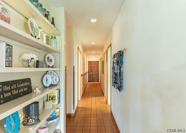 hallway featuring dark tile patterned flooring