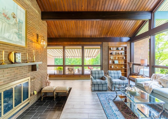 sunroom featuring vaulted ceiling and a fireplace