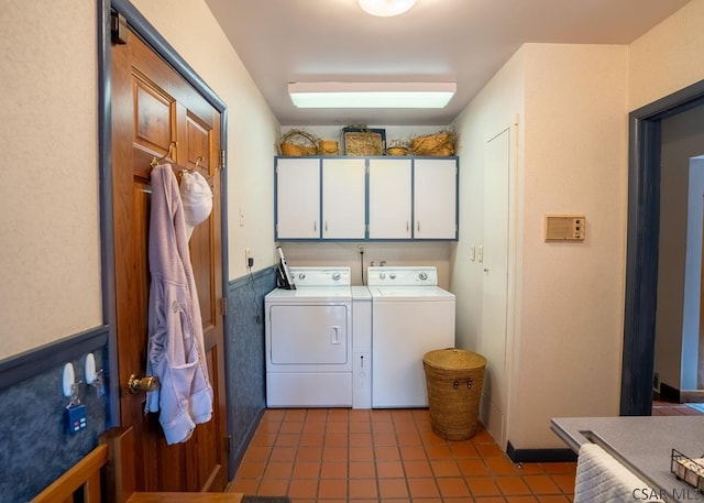 washroom featuring cabinets, dark tile patterned flooring, and independent washer and dryer